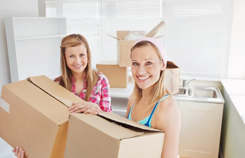 Professional removals team handling furniture and boxes during a house move