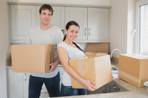 Local removals team handling furniture in a Catford street